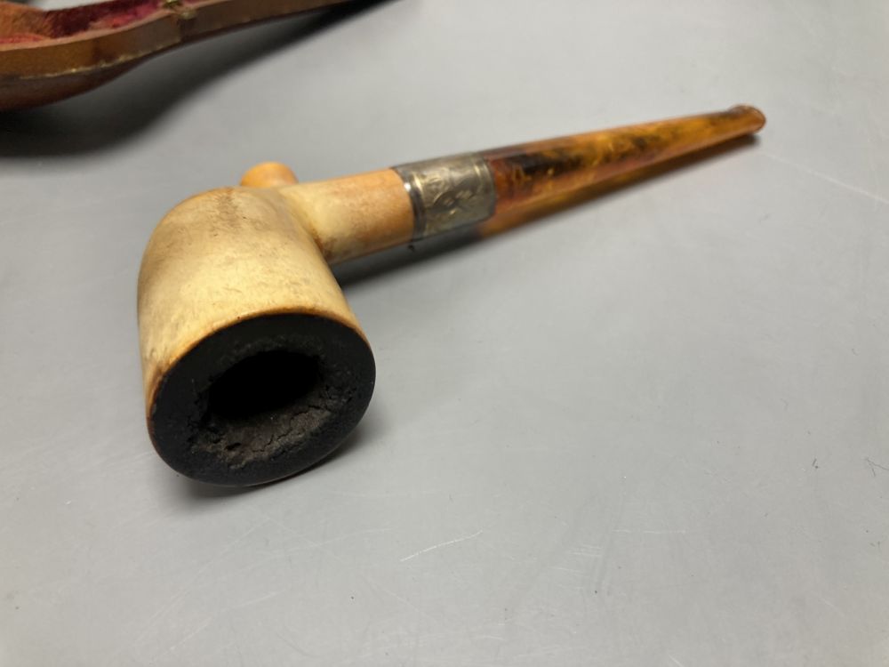 A silver-mounted Meerschaum pipe and two cut-throat razors, all cased